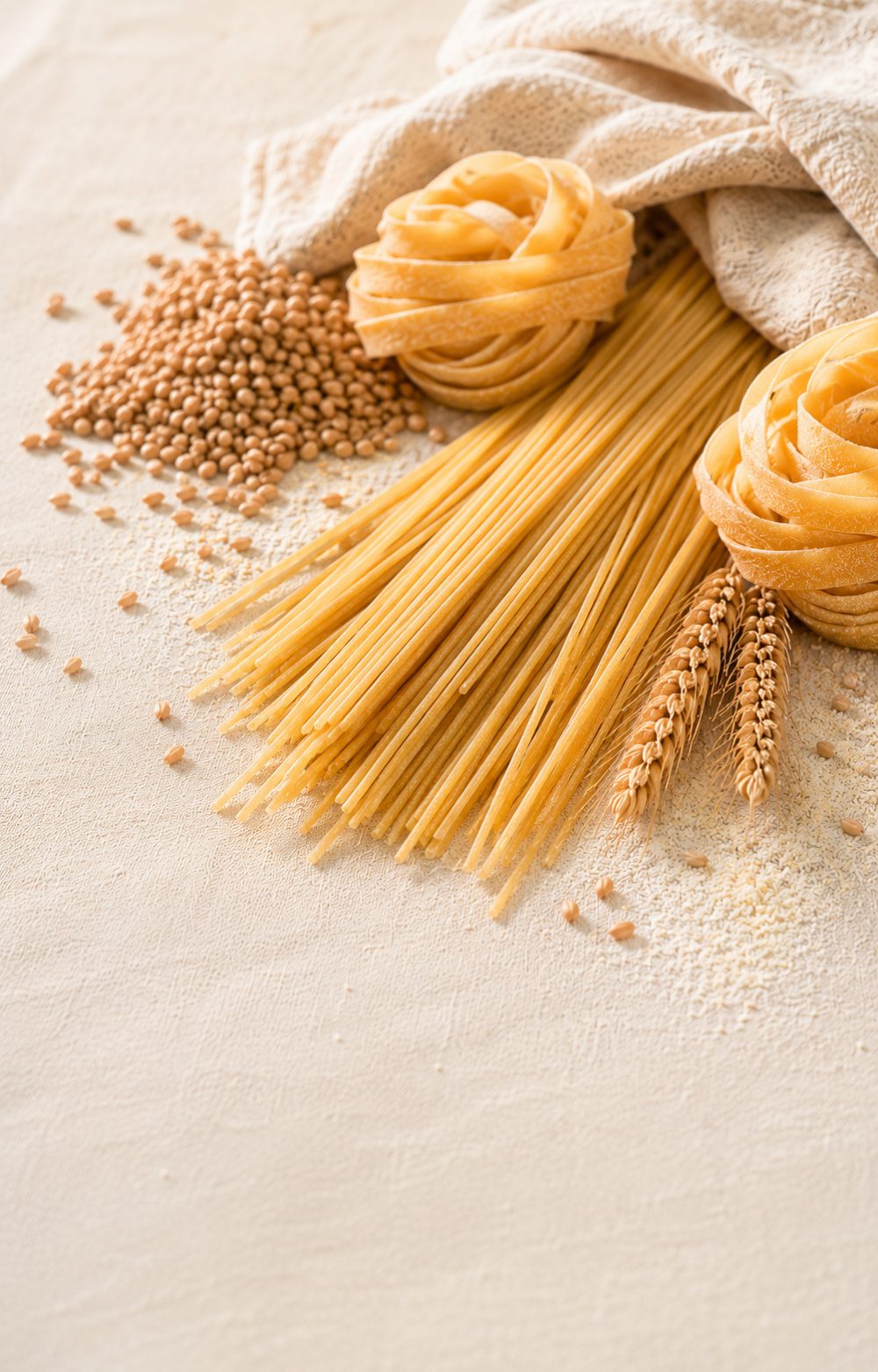 Bronze-die semolina pasta nests and spaghetti on dark slate
